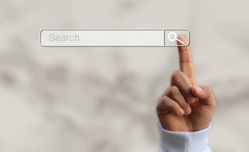 Finger on a screen with search